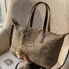e1e2e730-b950-4aec-a226-4e389ef14881-Max-Origin.jpg Woven Crossbody Bag with Gold Chain Accents